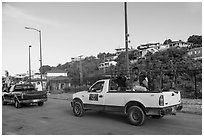 Residents riding in back of pick-up trucks, Cruz Bay. Saint John, US Virgin Islands ( black and white)