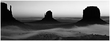 Monument Valley mittens at sunrise with fog. Monument Valley Tribal Park, Navajo Nation, Arizona and Utah, USA (Panoramic black and white)