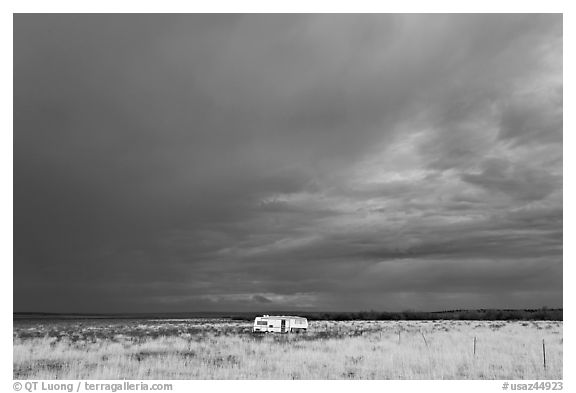 Trailer and storm sky. Arizona, USA (black and white)