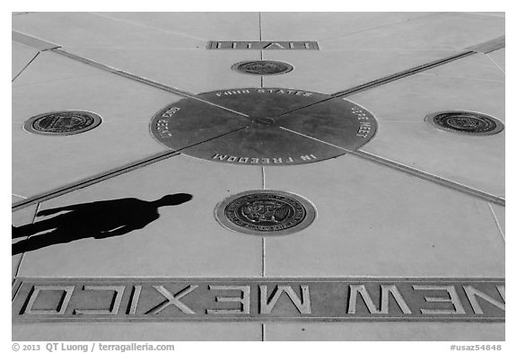 Shadow and state seals. Four Corners Monument, Arizona, USA