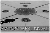 Shadow and state seals. Four Corners Monument, Arizona, USA (black and white)