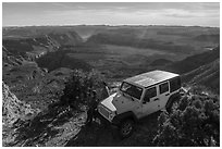 Jeep and visitors on rim edge of Grand Canyon. Grand Canyon-Parashant National Monument, Arizona, USA ( black and white)