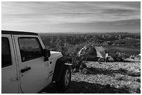 Jeep and tent on Canyon Rim, Twin Point. Grand Canyon-Parashant National Monument, Arizona, USA ( black and white)