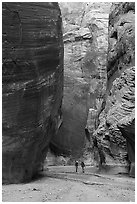 Hikers below huge walls, Paria Canyon. Vermilion Cliffs National Monument, Arizona, USA ( black and white)