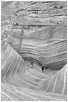 Hikers at the bottom of the Wave. Coyote Buttes, Vermilion cliffs National Monument, Arizona, USA (black and white)