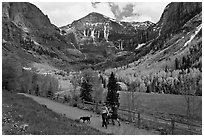 Family hiking on trail towards Bridalveil Falls in the spring. Telluride, Colorado, USA ( black and white)