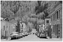 Historic brick buildings and slope with newly leafed aspens. Telluride, Colorado, USA (black and white)