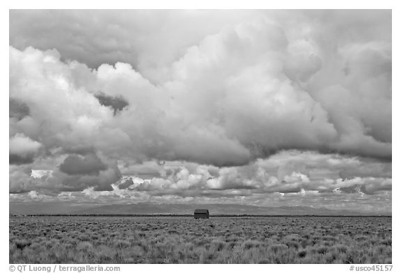 Lonely house on plain under clouds. Colorado, USA (black and white)