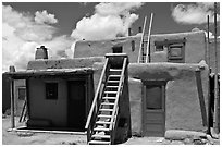 Multi-story pueblo houses with ladders. Taos, New Mexico, USA (black and white)