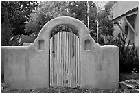 Blue door and adobe yard wall. Taos, New Mexico, USA ( black and white)