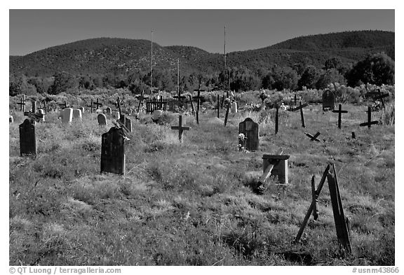 Headstones in grassy area, cemetery, Picuris Pueblo. New Mexico, USA