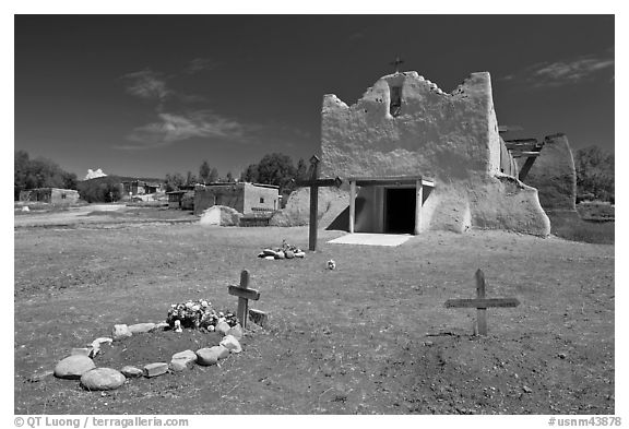 Graves and Picuris Church, Picuris Pueblo. New Mexico, USA (black and white)