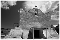 Facade of church covered with tightly compacted earth, clay, and straw, Picuris Pueblo. New Mexico, USA (black and white)