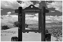 Historic marker framing high desert landscape. New Mexico, USA ( black and white)