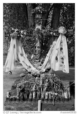 Cross festoned with popular devotion objects, Sanctuario de Chimayo. New Mexico, USA (black and white)