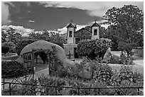 Gardens and walled courtyard, Sanctuario de Chimayo. New Mexico, USA (black and white)