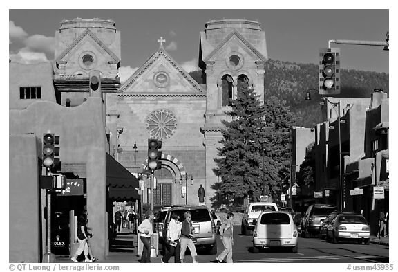 Pedestrians and street with cathedral, downtown. Santa Fe, New Mexico, USA (black and white)