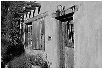 Door, window, and vigas (wooden beams). Santa Fe, New Mexico, USA ( black and white)