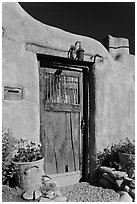 Wooden door and adobe wall. Santa Fe, New Mexico, USA (black and white)