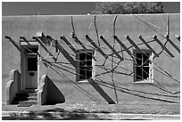 Adobe building tied up with plastic bags. Santa Fe, New Mexico, USA (black and white)
