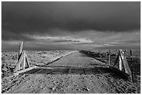 Cattle guard and unpaved road. New Mexico, USA ( black and white)
