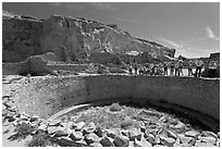 Tourists during a tour of Pueblo Bonito. Chaco Culture National Historic Park, New Mexico, USA (black and white)