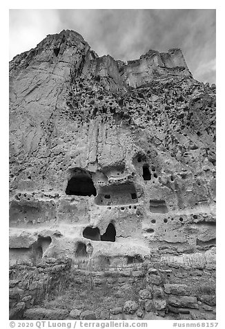 Cliff with multistory dwellings foundations and cavates. Bandelier National Monument, New Mexico, USA (black and white)