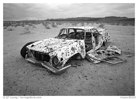 Car wreck used as a shooting target. Nevada, USA (black and white)