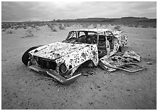Car wreck used as a shooting target. Nevada, USA (black and white)