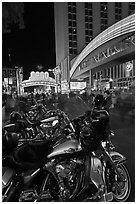 Harley-Davidson motorcycles on downtown street at night. Reno, Nevada, USA (black and white)