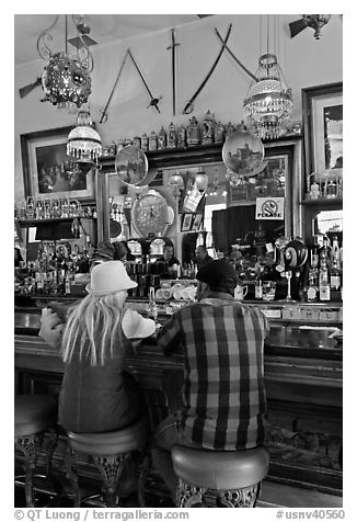 Man and woman sitting in saloon. Virginia City, Nevada, USA (black and white)