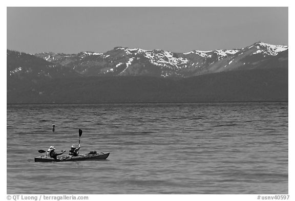 Kayak, turquoise waters and snowy mountains, East Shore, Lake Tahoe, Nevada. USA