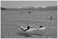 Children playing in water, and distant snowy mountains, Sand Harbor, Lake Tahoe, Nevada. USA ( black and white)