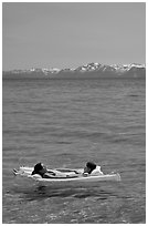 Girls laying on floating mattress, Sand Harbor, East Shore, Lake Tahoe, Nevada. USA (black and white)