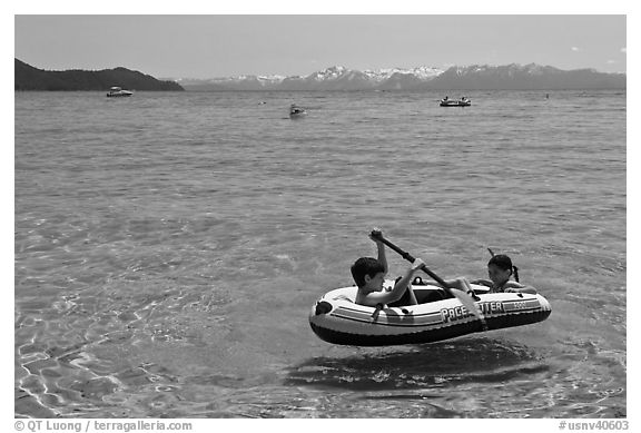 Children playing in inflatable boat, Sand Harbor, Lake Tahoe-Nevada State Park, Nevada. USA