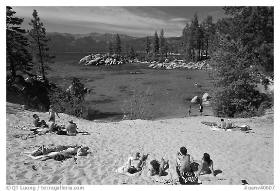 Young people sunbathing on sandy beach, Sand Harbor, Lake Tahoe, Nevada. USA