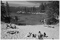 Young people sunbathing on sandy beach, Sand Harbor, Lake Tahoe, Nevada. USA ( black and white)