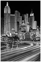 Traffic light trails and New York New York casino at night. Las Vegas, Nevada, USA (black and white)