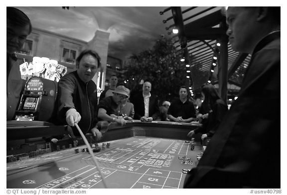 Dealer collecting during Craps game. Las Vegas, Nevada, USA (black and white)