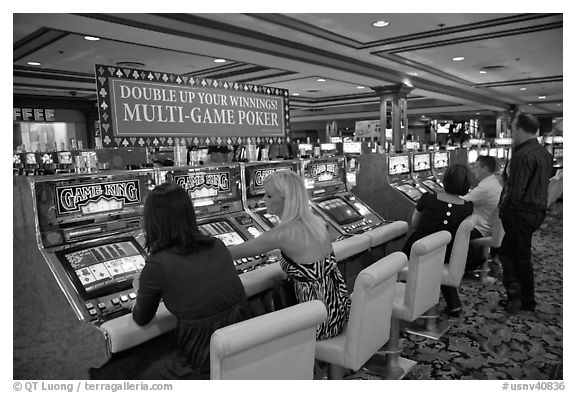 Gambling with gaming  machines. Las Vegas, Nevada, USA (black and white)