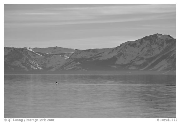 Kayak in the distance and mountains in winter, Lake Tahoe, Nevada. USA (black and white)