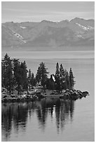 Cabin on lakeshore and snowy mountains, Lake Tahoe, Nevada. USA (black and white)