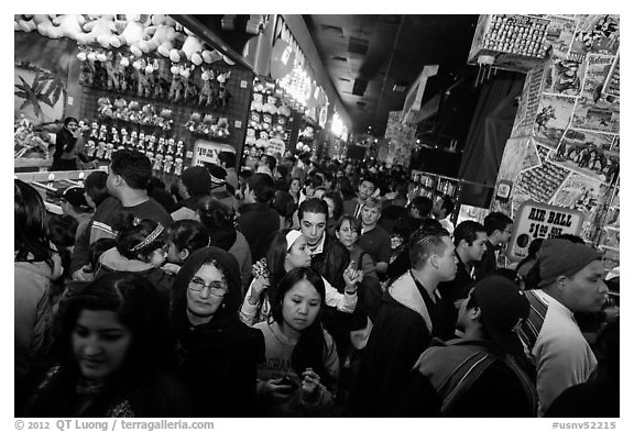 Densely packed crowds in circus arcade. Reno, Nevada, USA (black and white)