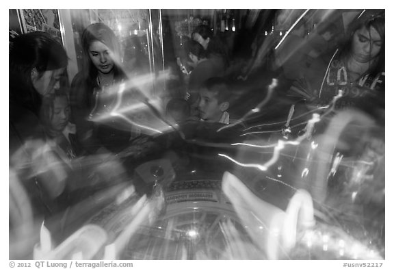 Fast moving lights and arcade game players. Reno, Nevada, USA (black and white)