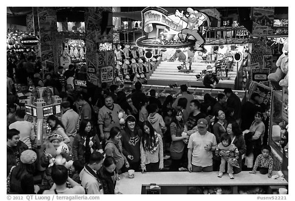 Families crowd arcade during holidays. Reno, Nevada, USA (black and white)