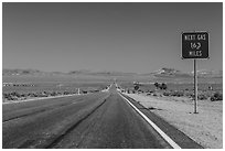 Highway and Next Gas 163 miles sign. Nevada, USA (black and white)