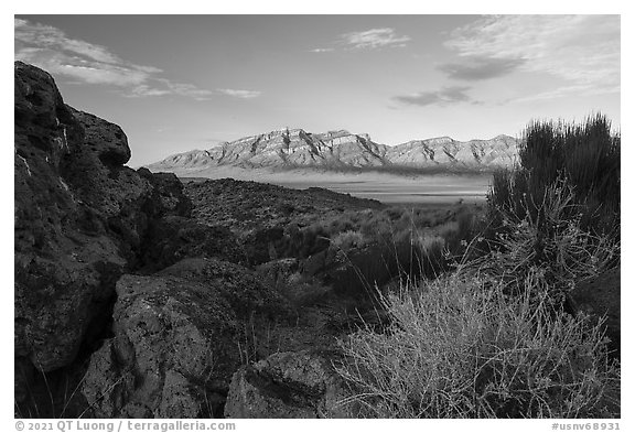 Ash boulders framing Worthington Mountains. Basin And Range National Monument, Nevada, USA (black and white)