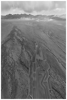 Aerial view of part of Michael Heizer's City leading to mountains. Basin And Range National Monument, Nevada, USA ( black and white)