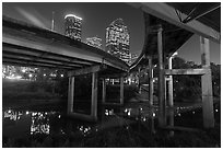 Skyline from under highway bridges at night. Houston, Texas, USA ( black and white)