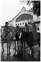 Cowboys in raincoats in front of Cowtown coliseum. Fort Worth, Texas, USA ( black and white)